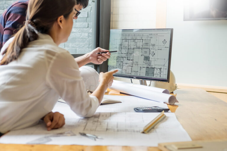 Professional architect designer and structural engineer team discussing building plan design project